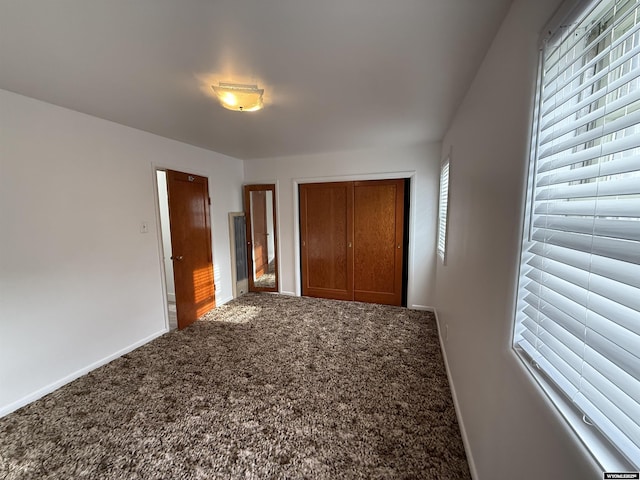 unfurnished bedroom with a closet and carpet