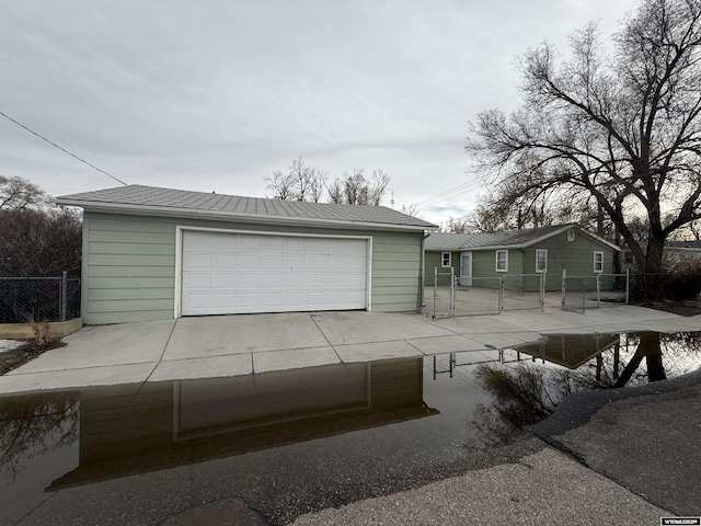 view of front facade featuring a garage and an outdoor structure