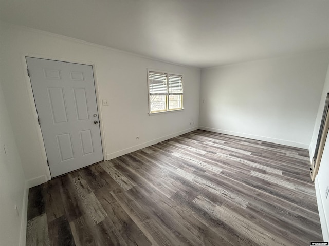 unfurnished room with dark wood-type flooring