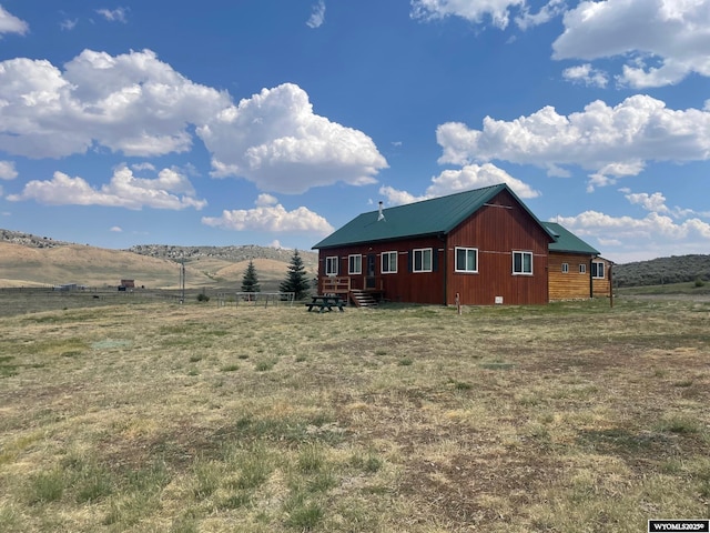 view of home's exterior with a mountain view and a rural view