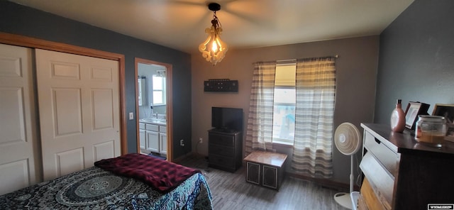 bedroom with ensuite bathroom and dark hardwood / wood-style flooring