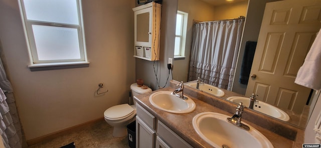 bathroom with vanity, curtained shower, tile patterned floors, and toilet