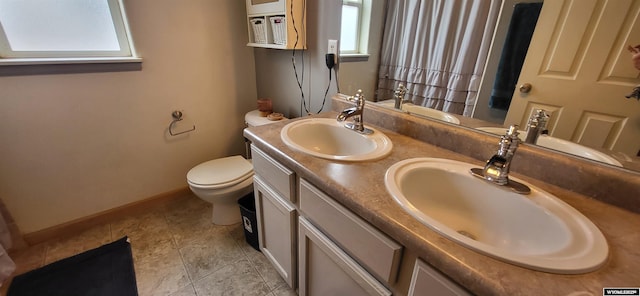 bathroom with tile patterned flooring, vanity, and toilet