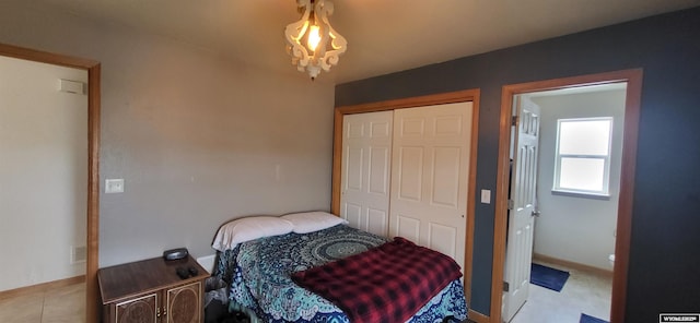 bedroom with light tile patterned floors and a closet