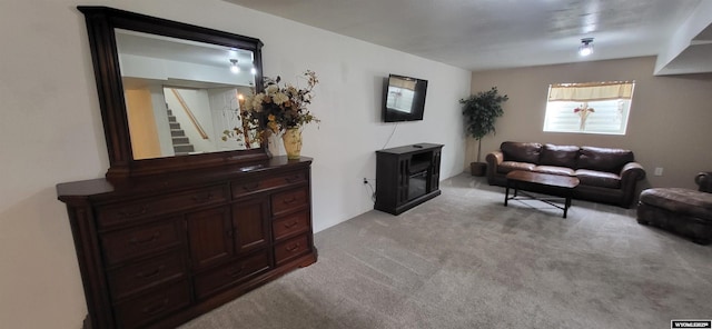 carpeted living room featuring a wood stove