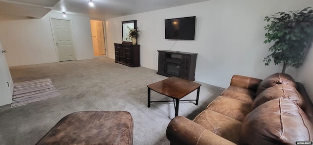 living room featuring light colored carpet and a fireplace