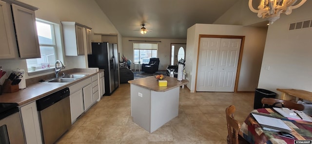 kitchen featuring gray cabinets, a kitchen island, appliances with stainless steel finishes, decorative light fixtures, and sink