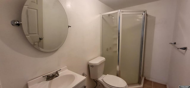 bathroom with tile patterned flooring, toilet, vanity, and walk in shower