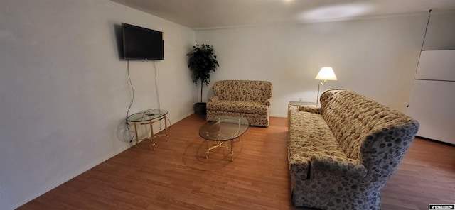 living area with hardwood / wood-style flooring