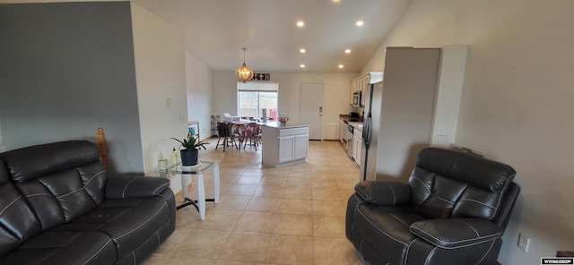 living room with high vaulted ceiling and light tile patterned floors