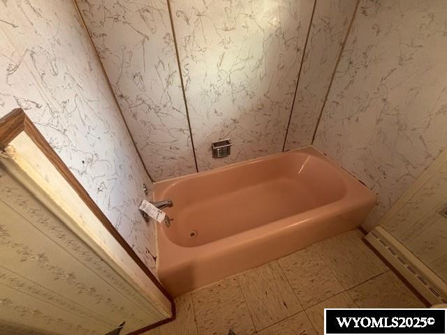 bathroom with a baseboard radiator, tile patterned floors, and shower / bath combination