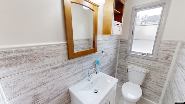 bathroom with tile walls, sink, and toilet