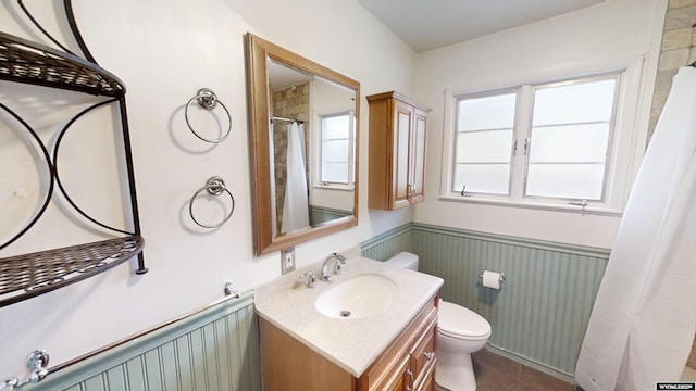 bathroom featuring vanity, toilet, and tile patterned flooring