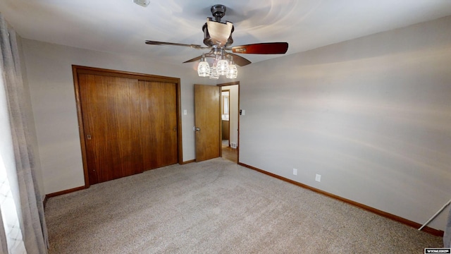 unfurnished bedroom with a closet, ceiling fan, and carpet flooring