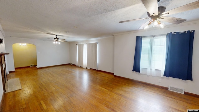 empty room featuring ceiling fan, hardwood / wood-style floors, and a textured ceiling