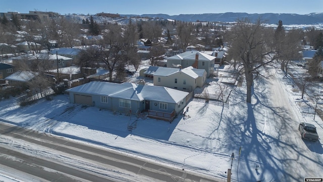 snowy aerial view with a mountain view