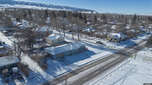 snowy aerial view with a mountain view