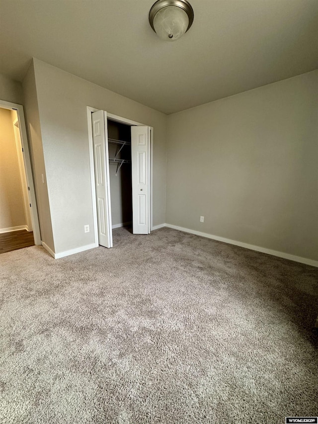 unfurnished bedroom with a closet and carpet