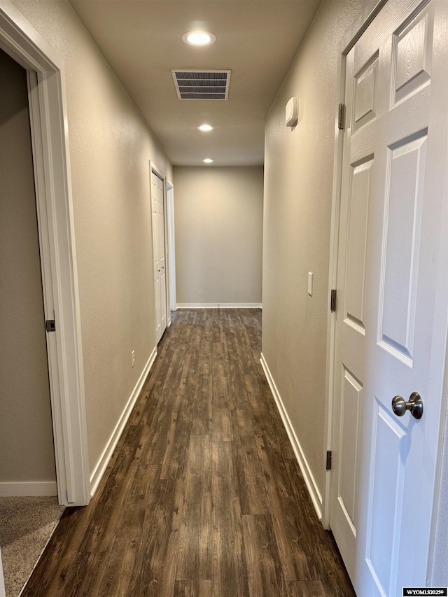 hallway with dark hardwood / wood-style floors