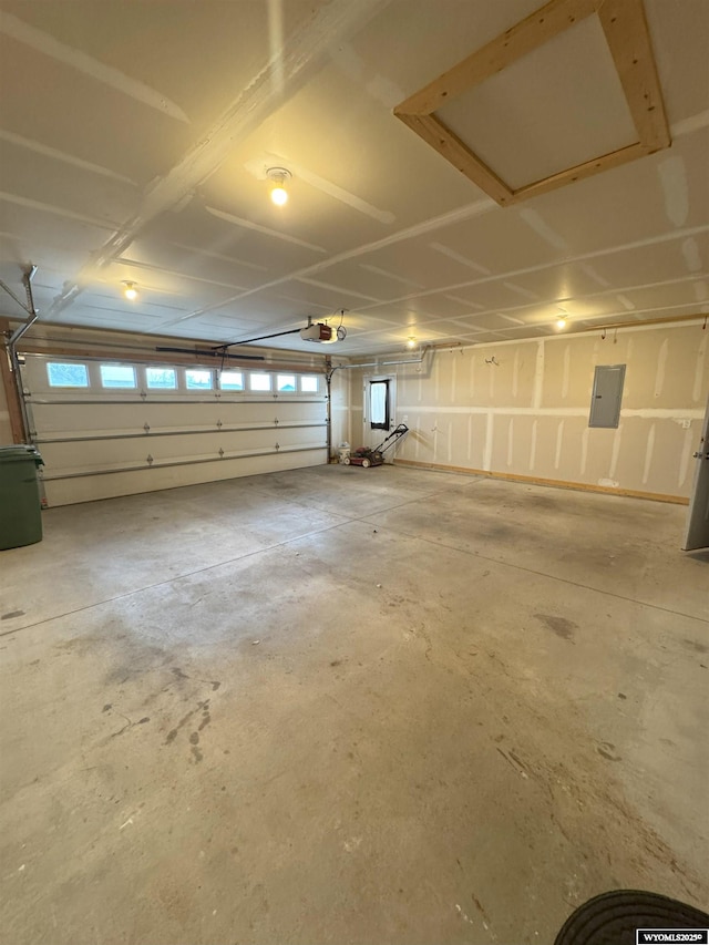 garage featuring a garage door opener and electric panel