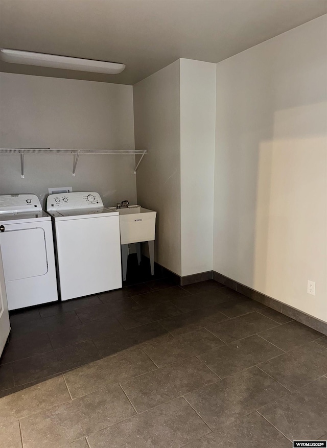 laundry area featuring washing machine and clothes dryer and sink