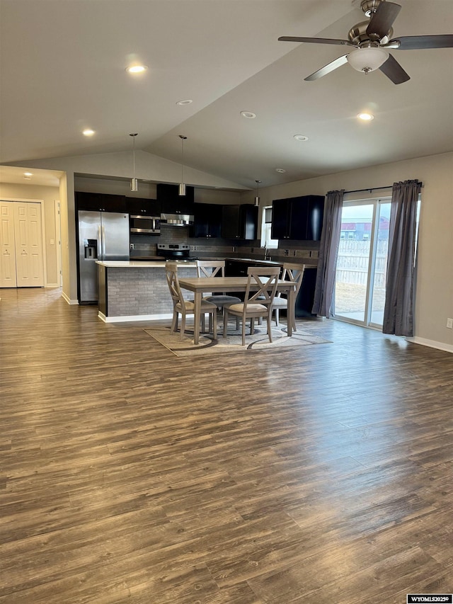 dining area with vaulted ceiling, dark hardwood / wood-style floors, and ceiling fan