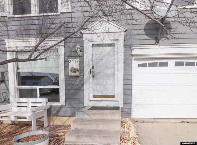 view of exterior entry with a garage