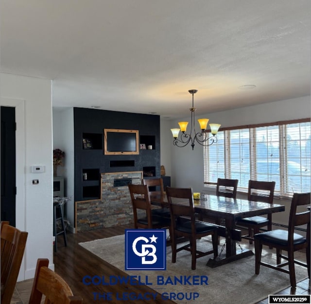 dining space with a notable chandelier and dark hardwood / wood-style flooring