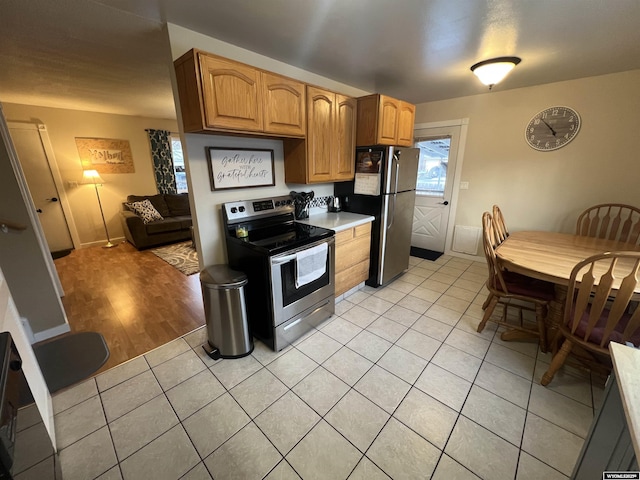 kitchen with stainless steel appliances and light tile patterned floors