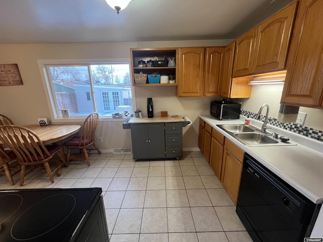 kitchen with sink, light tile patterned floors, and black appliances