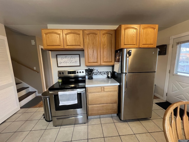 kitchen with stainless steel appliances and light tile patterned floors