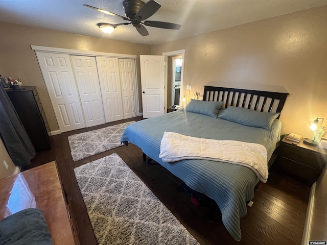 bedroom featuring ceiling fan, dark hardwood / wood-style flooring, and a closet