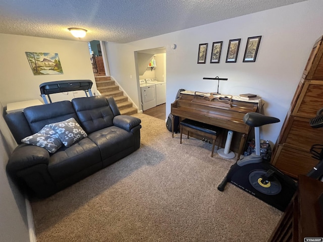 living room featuring carpet floors, independent washer and dryer, and a textured ceiling