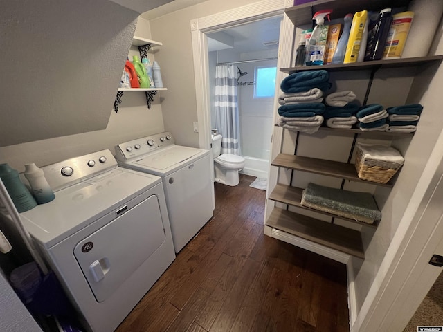 laundry area featuring washing machine and dryer and dark hardwood / wood-style floors