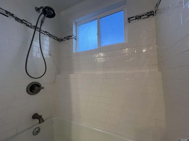 interior details featuring tiled shower / bath