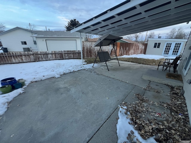 snow covered patio featuring an outbuilding