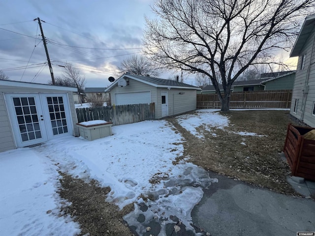 snowy yard featuring an outbuilding