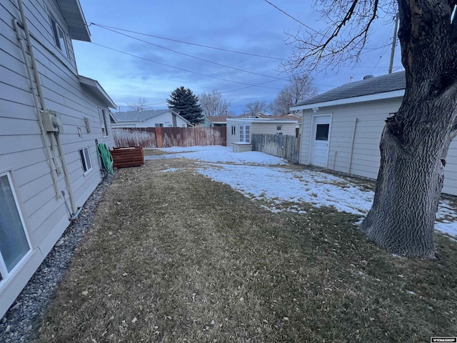 yard layered in snow featuring an outbuilding