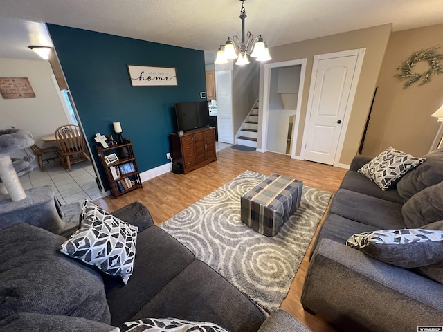 living room with hardwood / wood-style flooring and an inviting chandelier