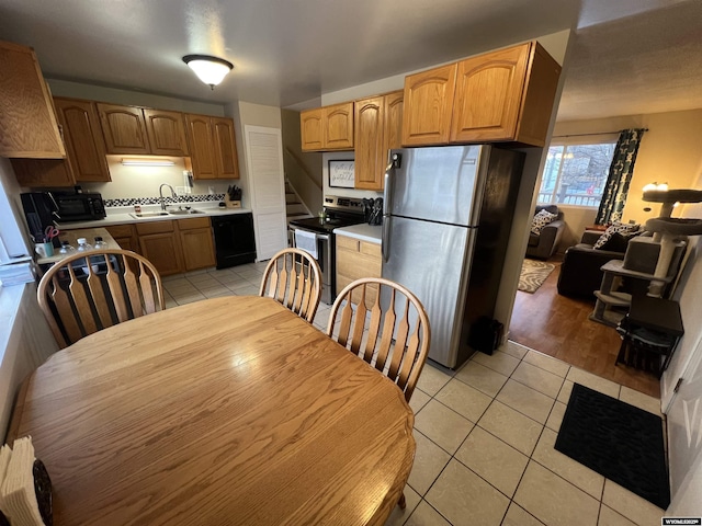 kitchen featuring sink, stainless steel appliances, and light tile patterned flooring