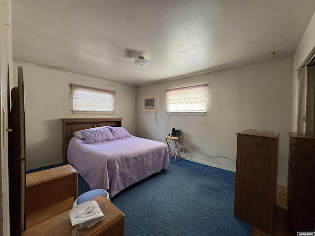 bedroom featuring a wall mounted air conditioner and dark carpet