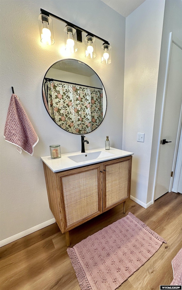 bathroom with vanity and hardwood / wood-style floors