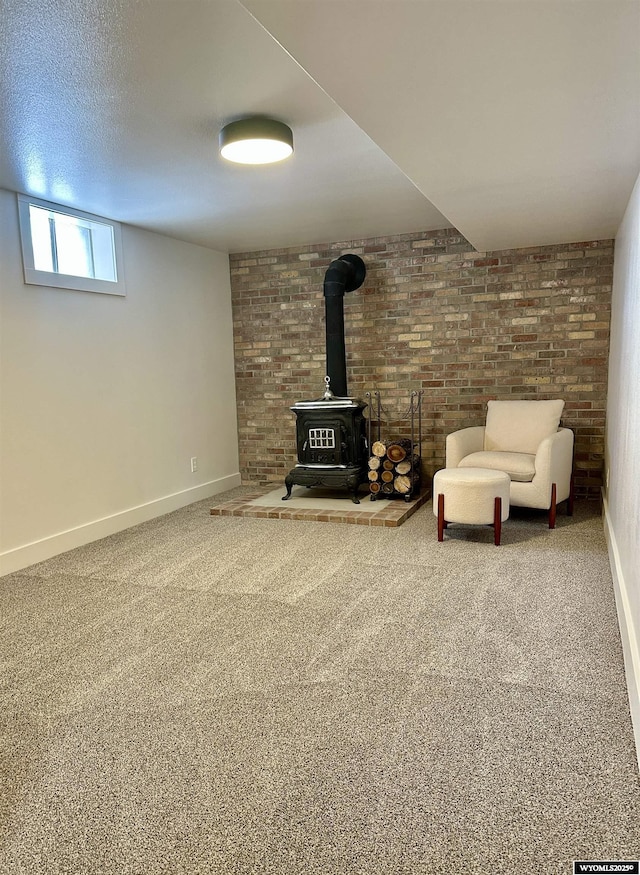 unfurnished living room featuring brick wall, carpet flooring, a textured ceiling, and a wood stove