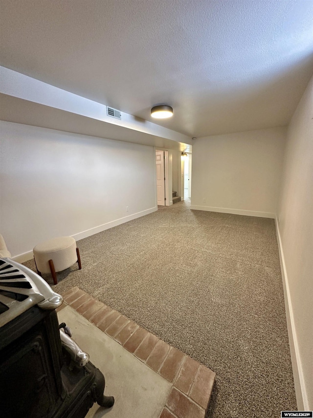 interior space featuring carpet floors and a textured ceiling