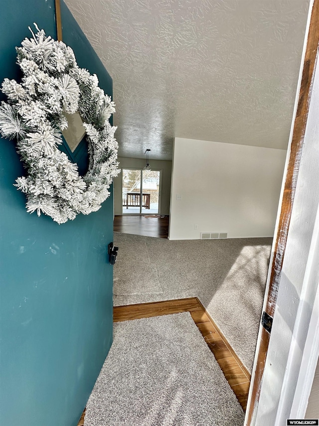 interior space with hardwood / wood-style floors and a textured ceiling