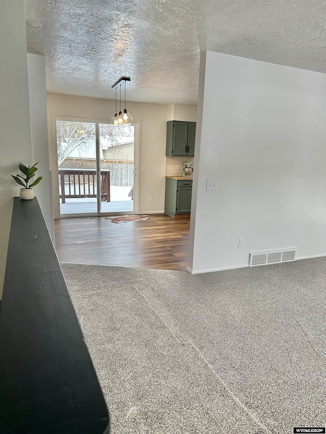 interior space with carpet flooring and a textured ceiling