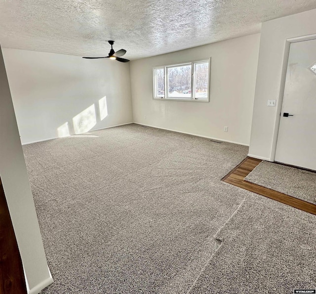 interior space featuring ceiling fan and a textured ceiling