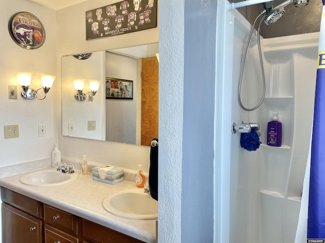 bathroom featuring walk in shower and vanity