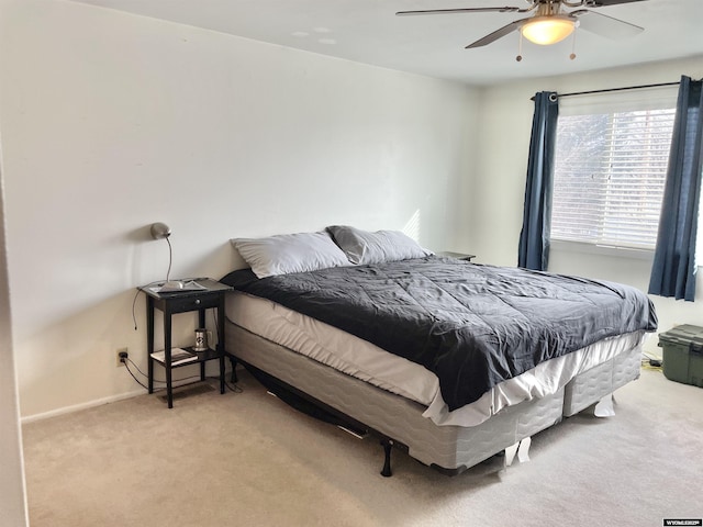 bedroom featuring light colored carpet and ceiling fan