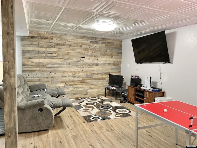 living room featuring wood-type flooring and wooden walls